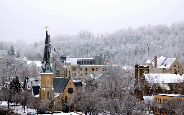 Winter scene of downtown Red Wing, featuring a church overlooking the buildings below.