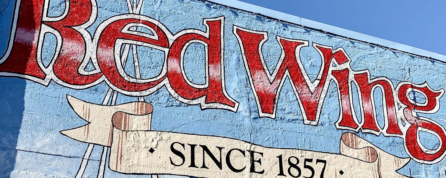 Mural of Red Wing. Text "Red Wing" with a banner "since 1857". Blue background