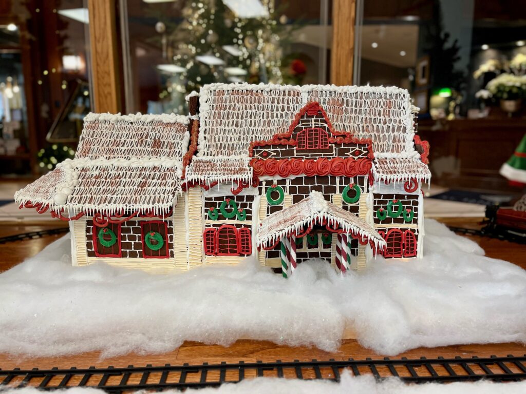gingerbread house in red white and green frosting