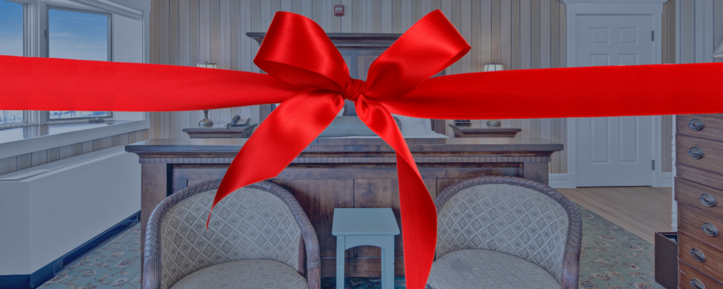 Big Red Bow across a St. James Hotel guest room with two chairs and a bed